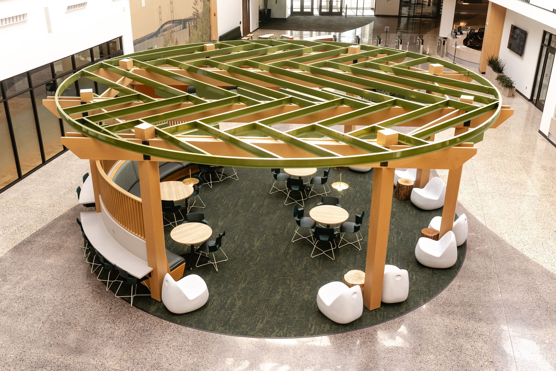 Round wooden study table with stools in a bright indoor room
