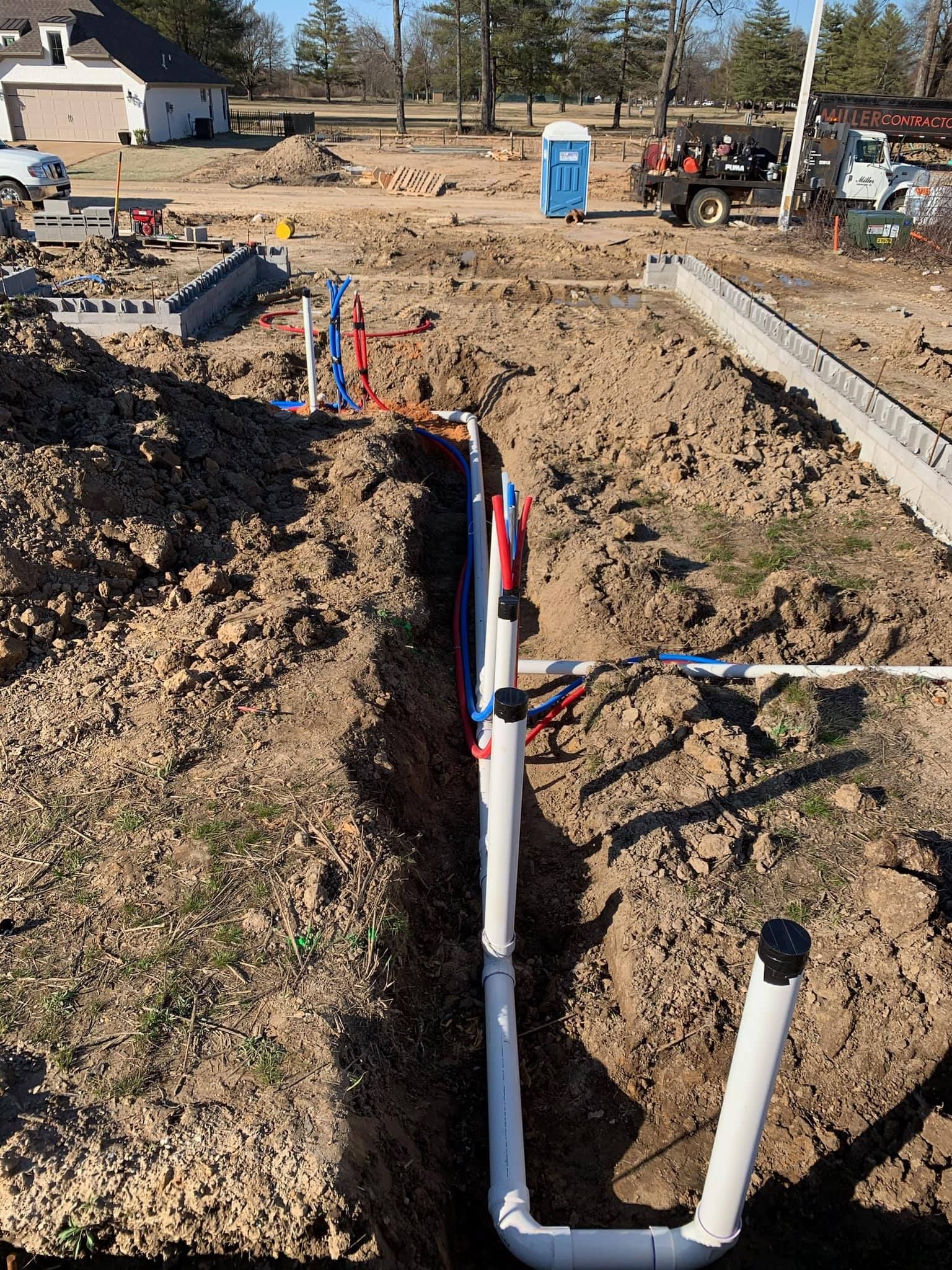 A pipe is being installed in the dirt in a construction site.