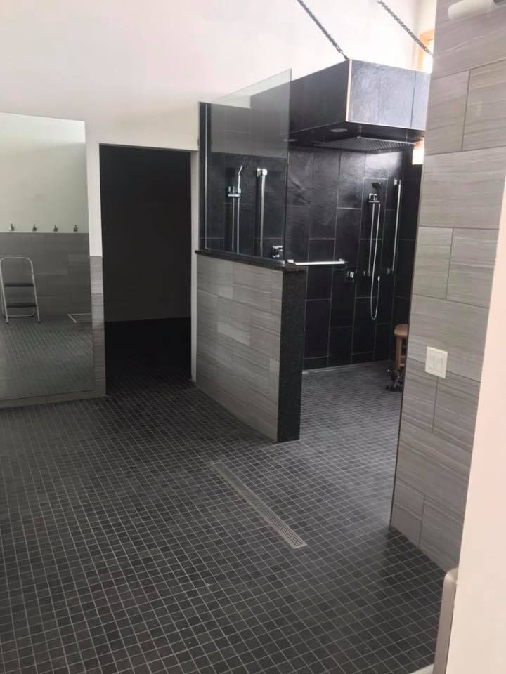 An empty room with a black tile floor