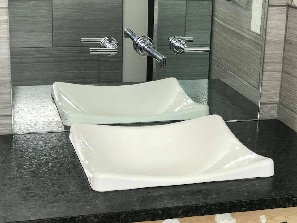 A bathroom with two sinks and a mirror