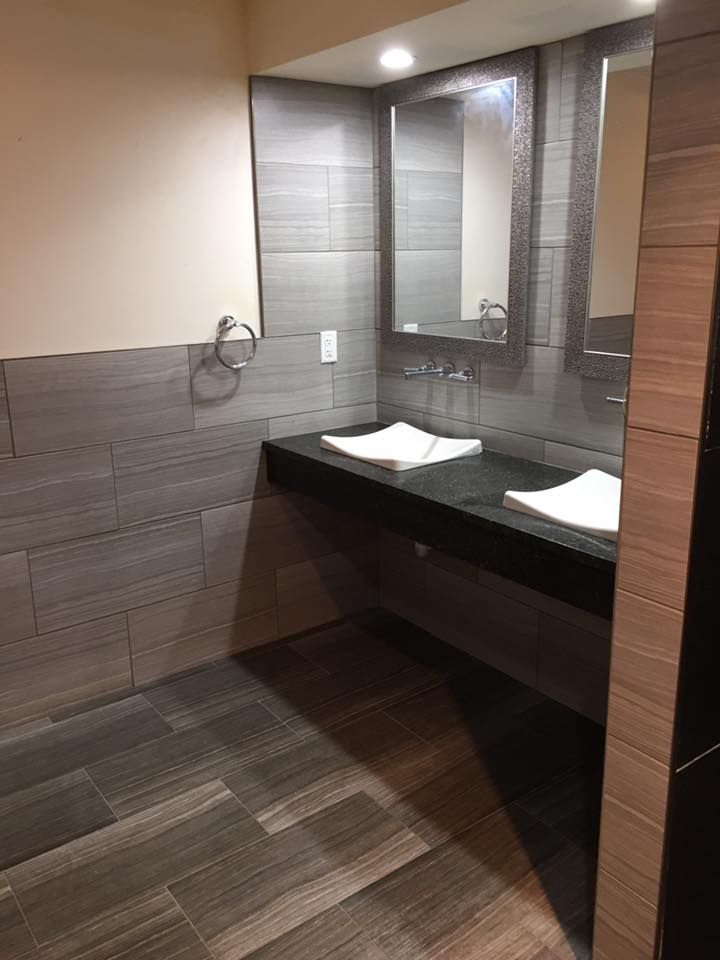 A bathroom with two sinks and a mirror.