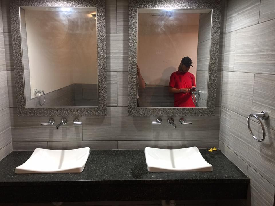 A bathroom with two sinks and two mirrors