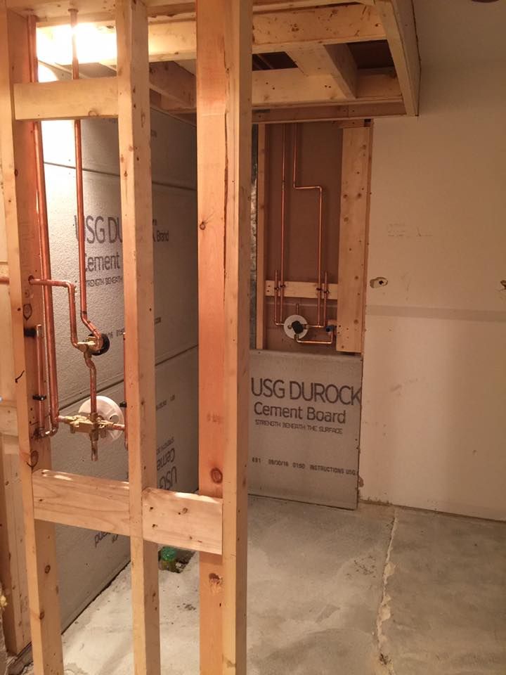 A bathroom under construction with usg durock cement board on the wall