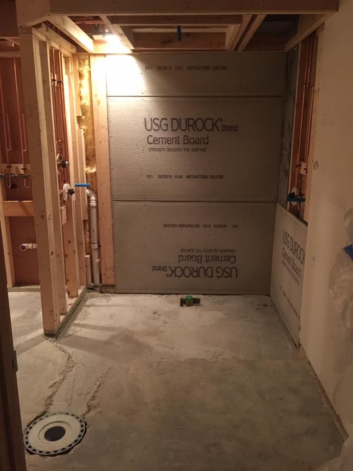 A bathroom under construction with usg durock cement board on the wall.
