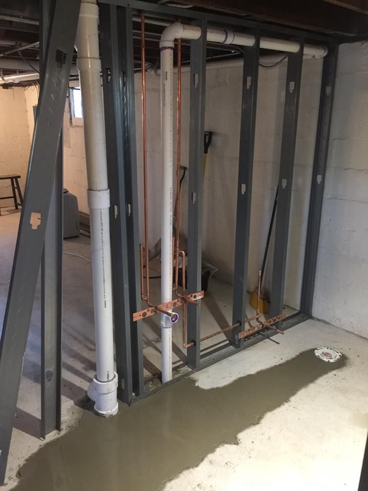 A basement with a lot of pipes coming out of it.