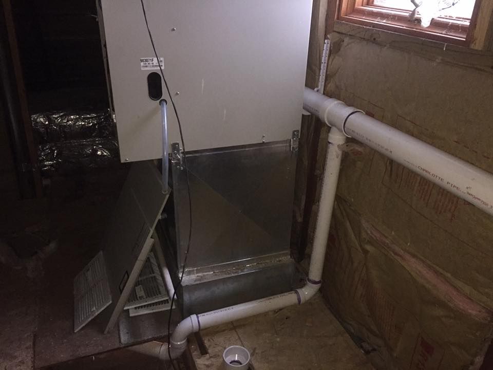 A room with a heater and pipes in it.