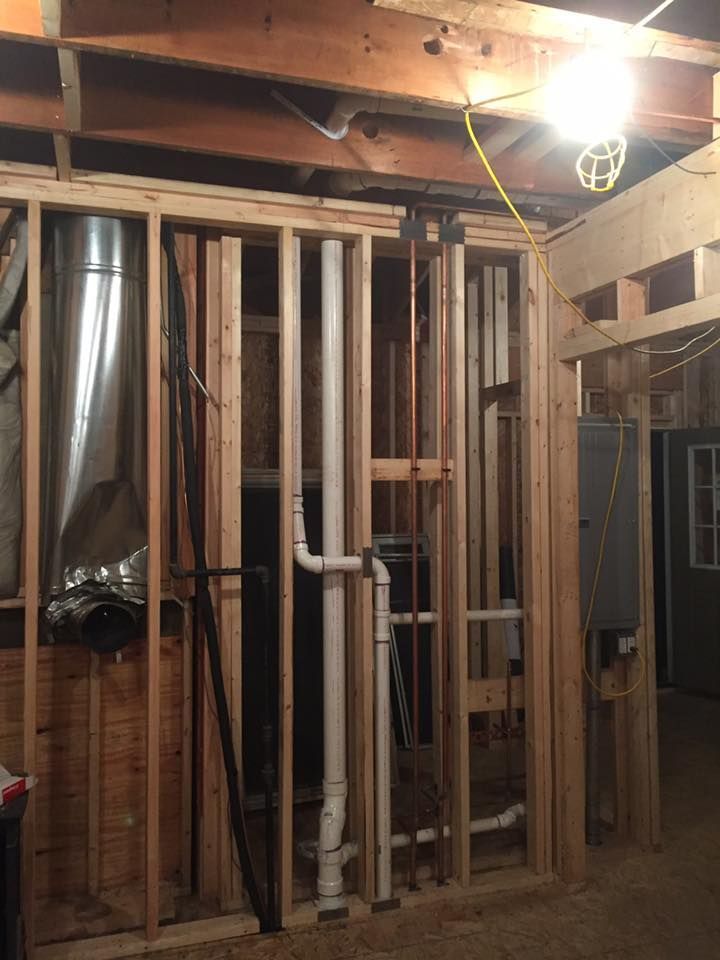 A room that is being built with a lot of pipes