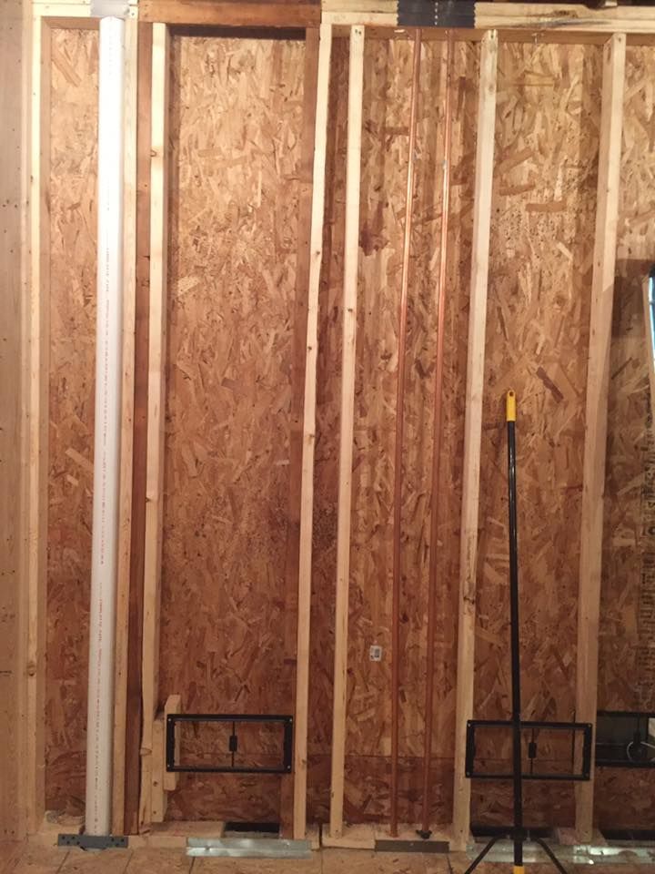 A wooden wall is being built in a house.