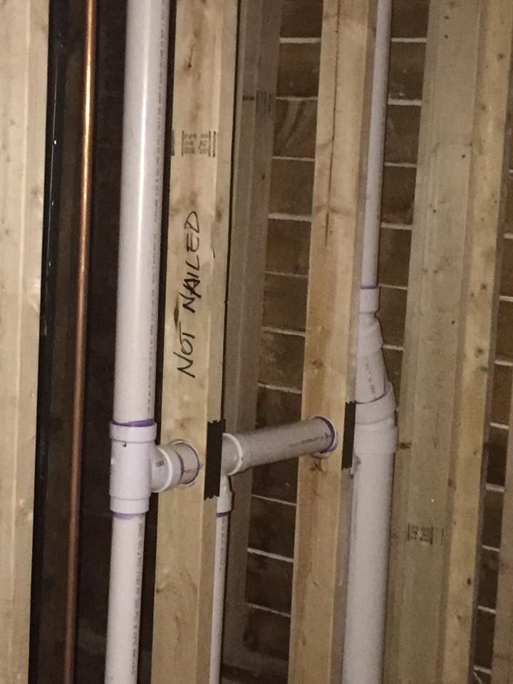 A wooden wall with pipes and a sign that says not nailed