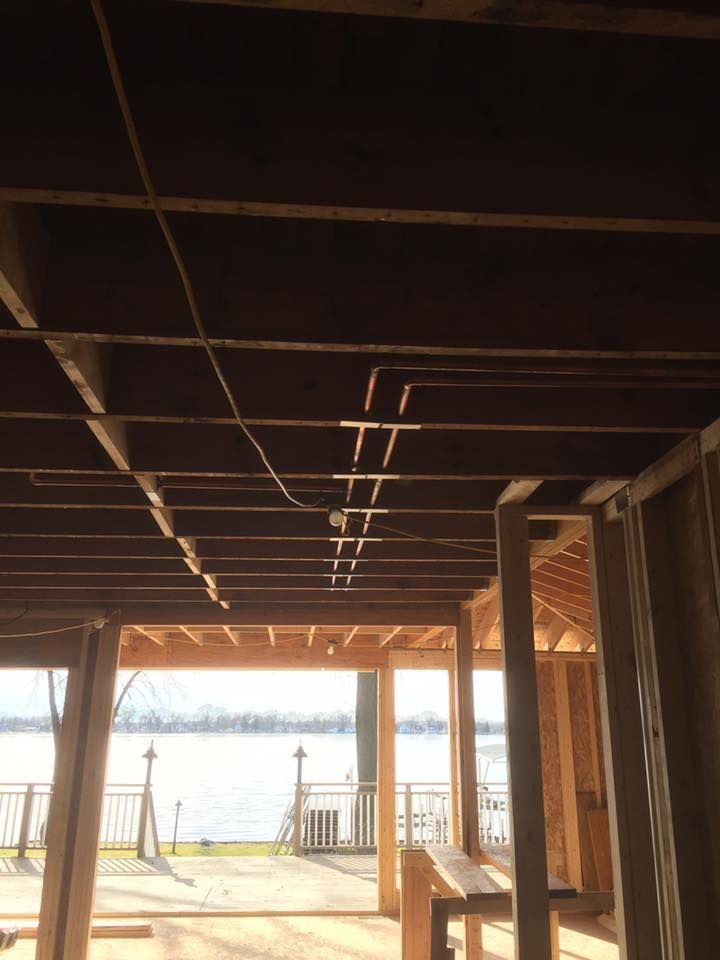 A house under construction with a view of a lake