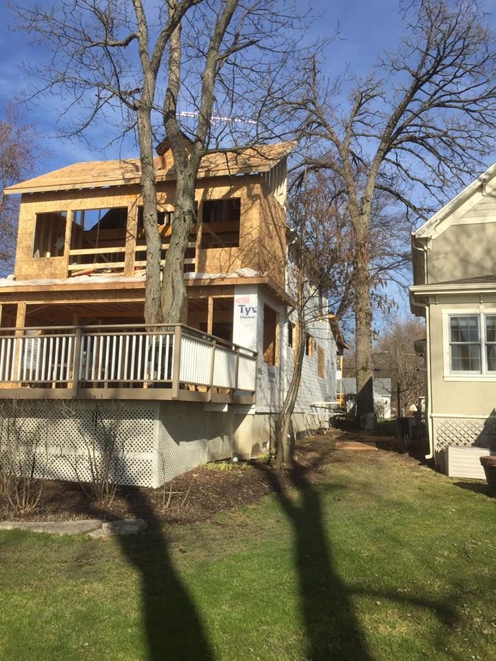 A house under construction with a deck in the backyard.