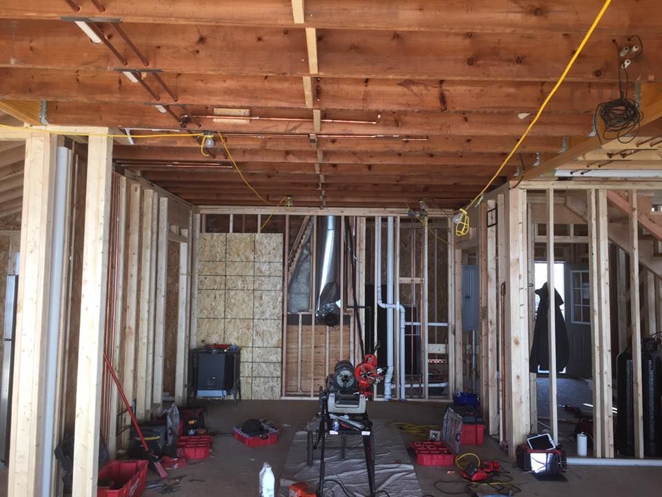 The inside of a building under construction with tools on the floor