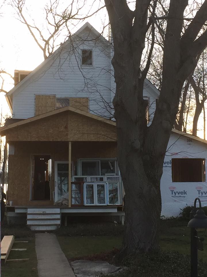 A white house with styrofoam on the side of it