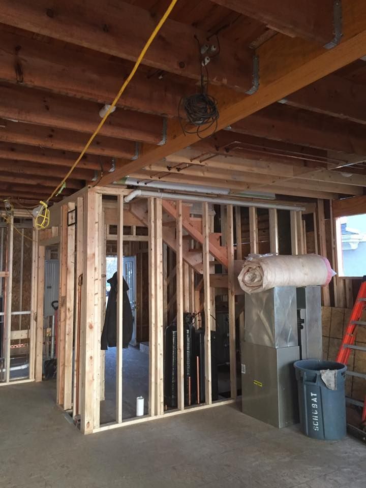 A staircase is being built in a room with a ladder