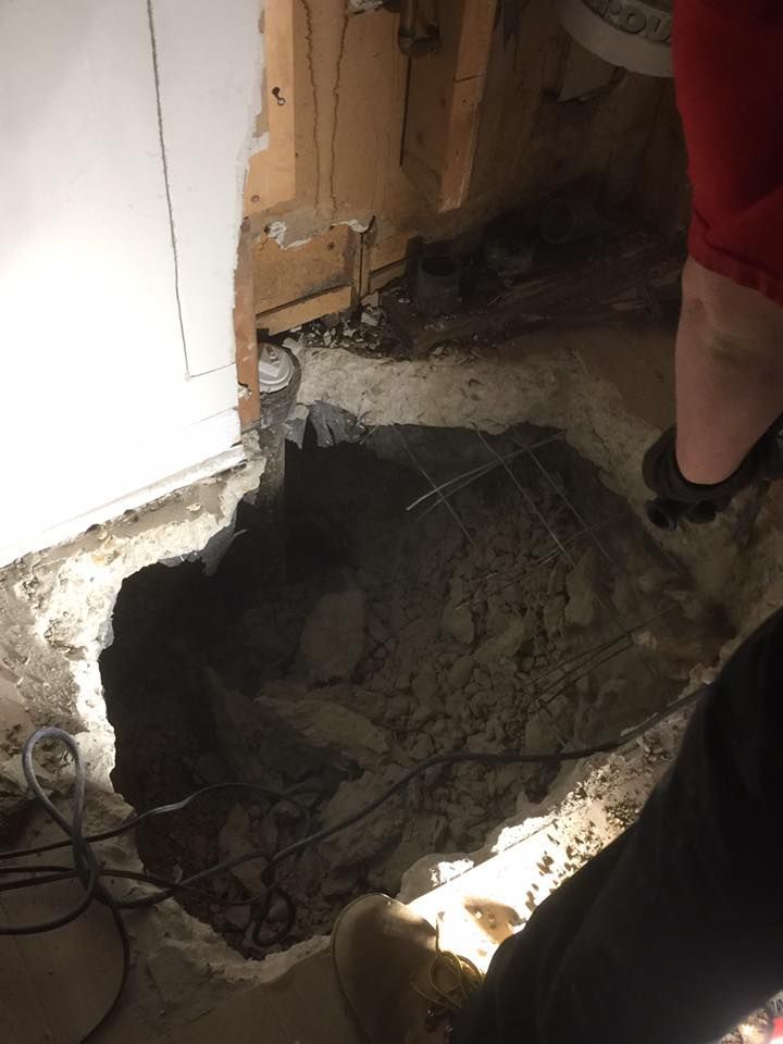 A person is standing in a hole in the floor.