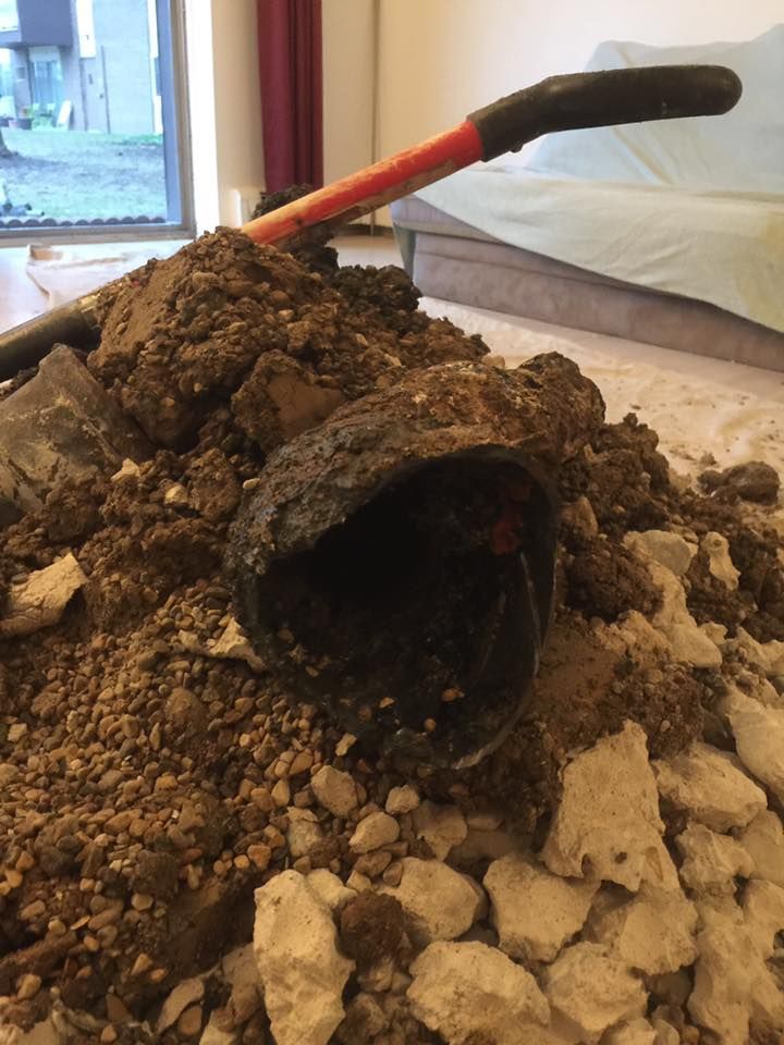 A shovel is laying on top of a pile of dirt and rocks.