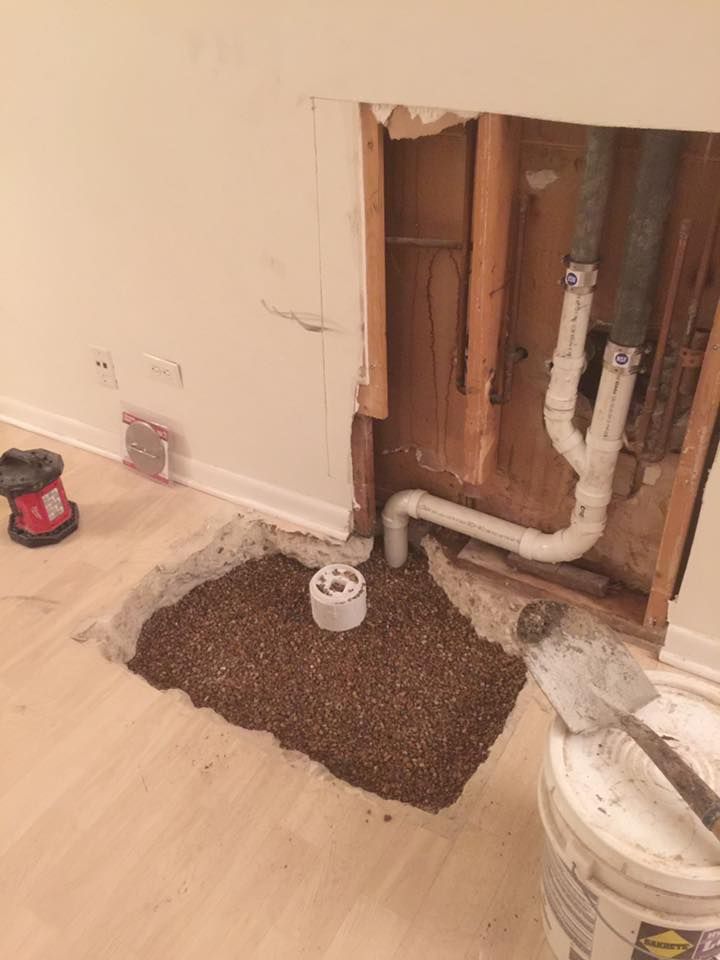 A hole in the wall with pipes coming out of it.
