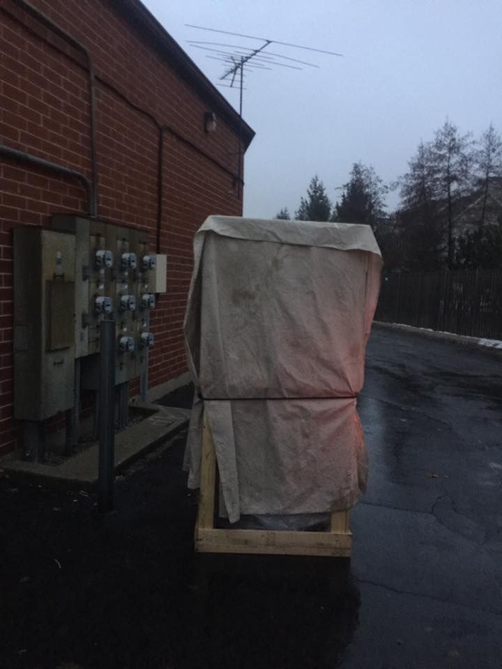 A brick building with a wooden crate in front of it