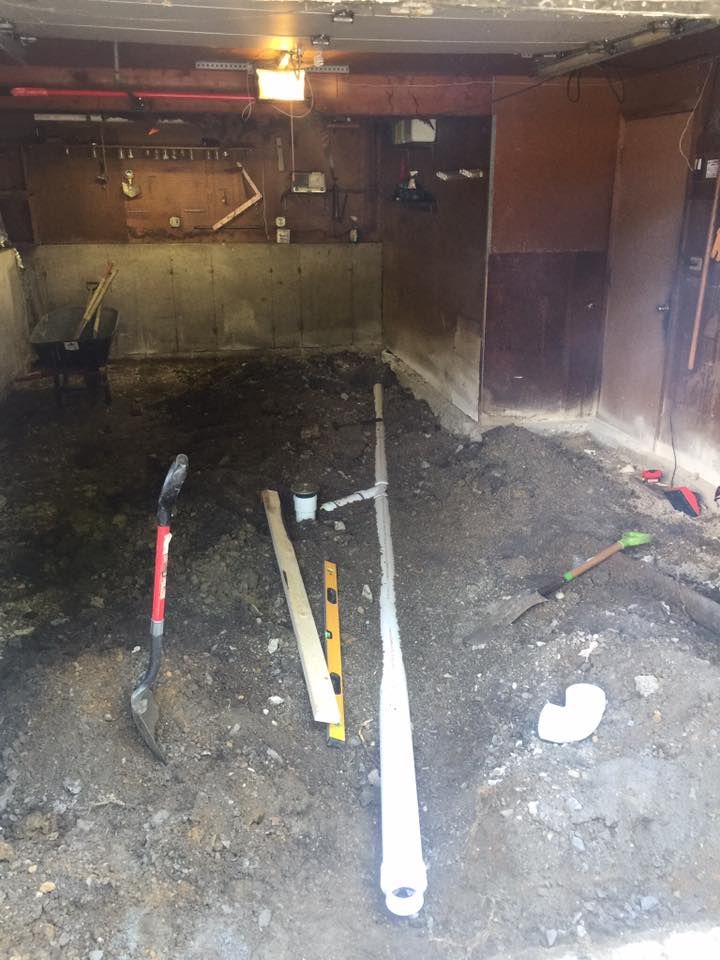 A garage with a lot of dirt and tools in it.