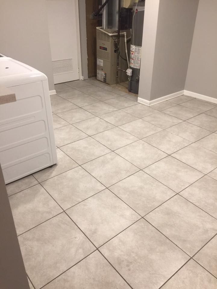 A laundry room with tile floors and a washer and dryer.