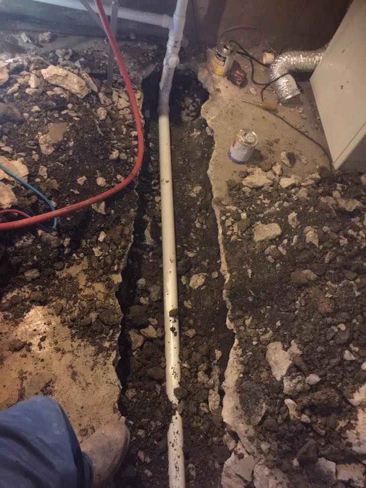 A hole in the ground with a pipe in it