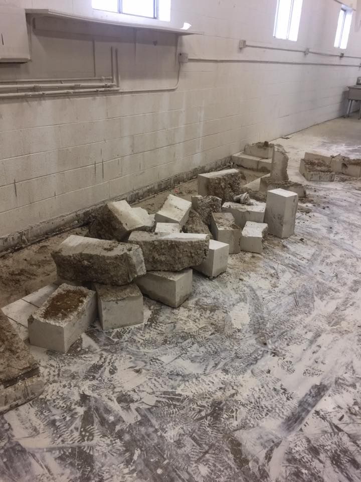 A pile of bricks on the floor of a building.