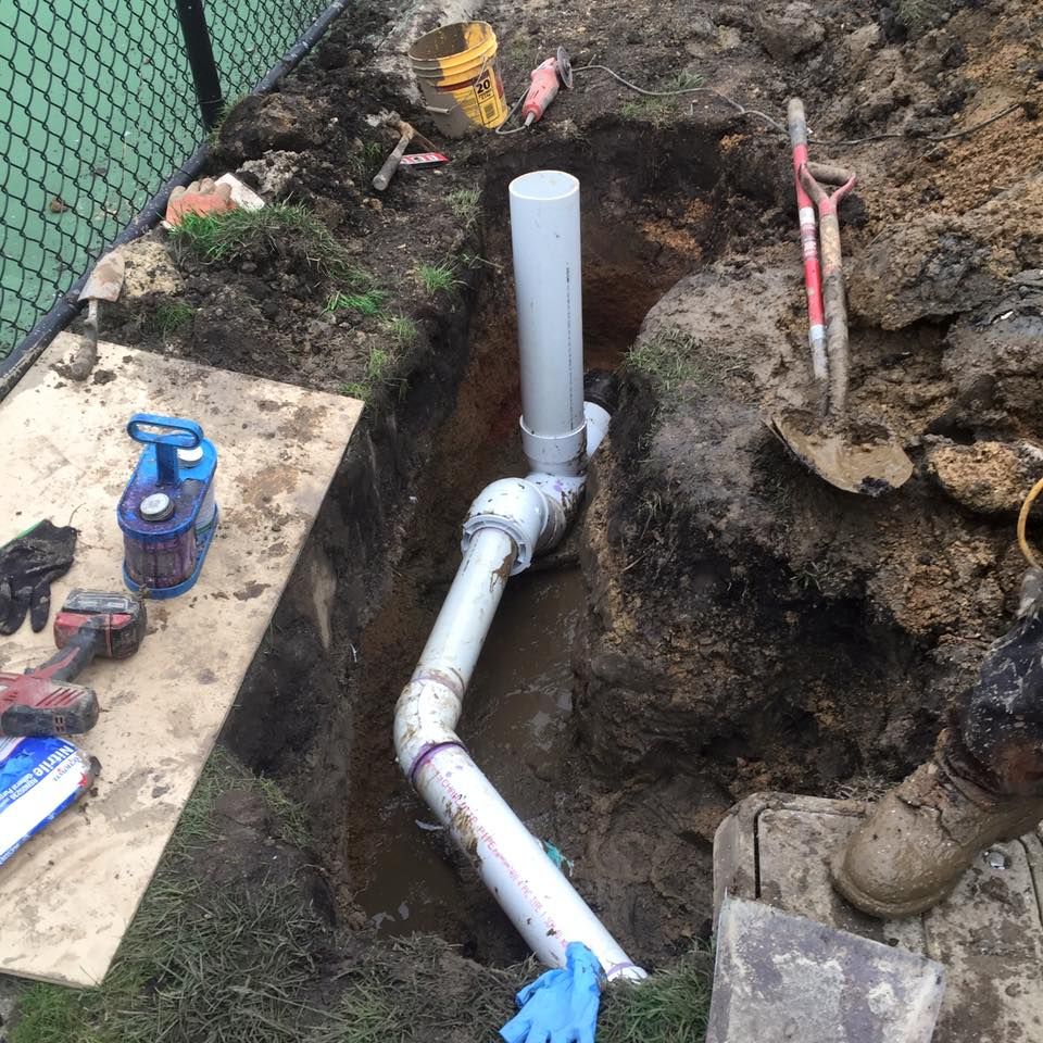 A pipe is being installed in a hole in the ground.