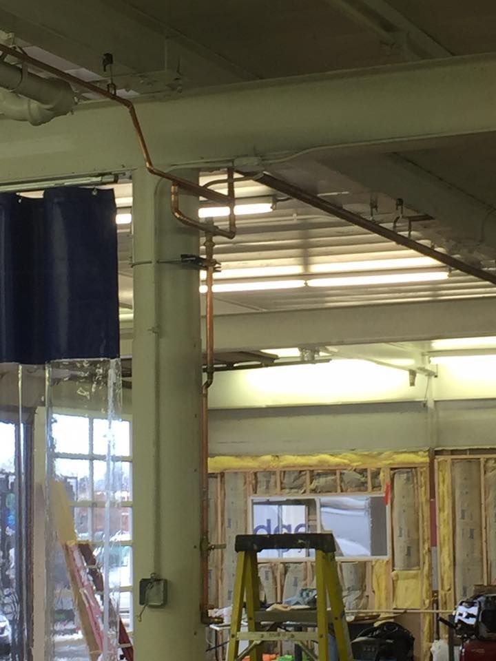 A ladder is in the middle of a building under construction