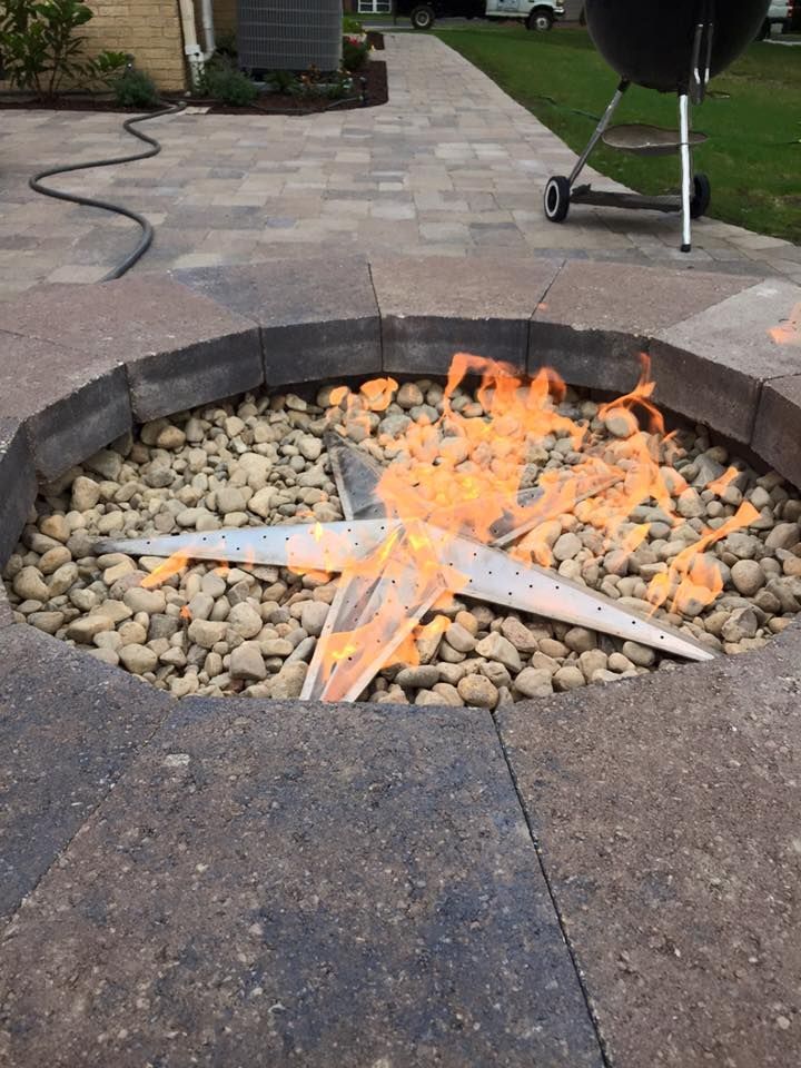 A fire pit with a star in the middle of it