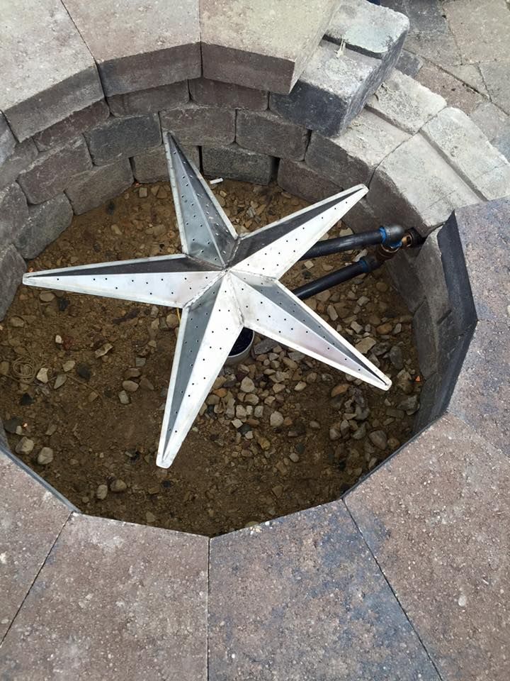 A fire pit with a star in the middle of it