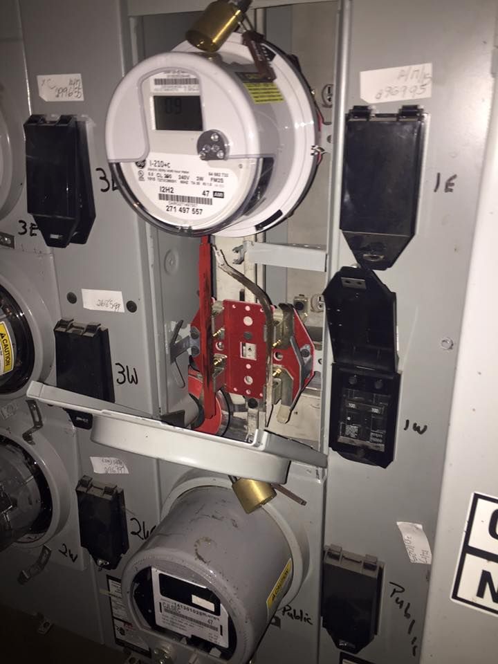 A close up of a electrical panel with a meter on it.
