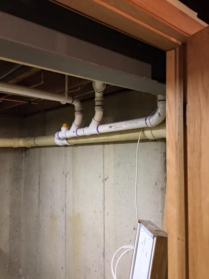 A room with a lot of pipes hanging from the ceiling