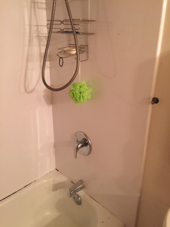 A bathroom with a bathtub , shower , and sponge.