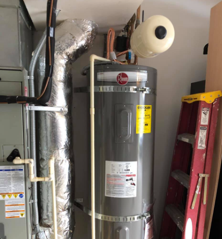 Water heater with expansion tank and ductwork in a utility room; a red ladder leans against the wall.