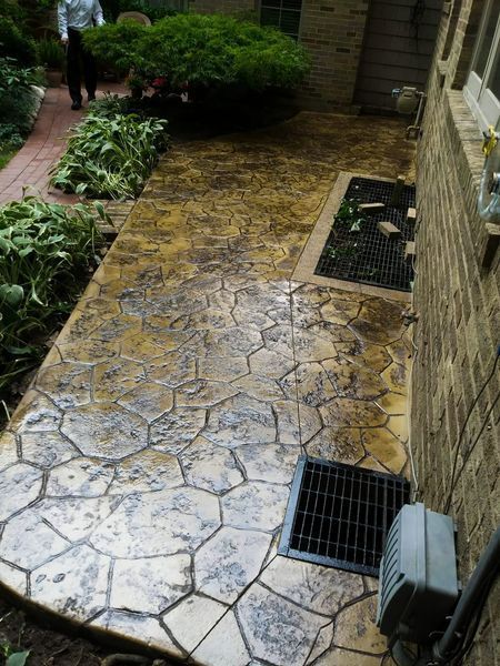 A brick building with a concrete walkway leading to it