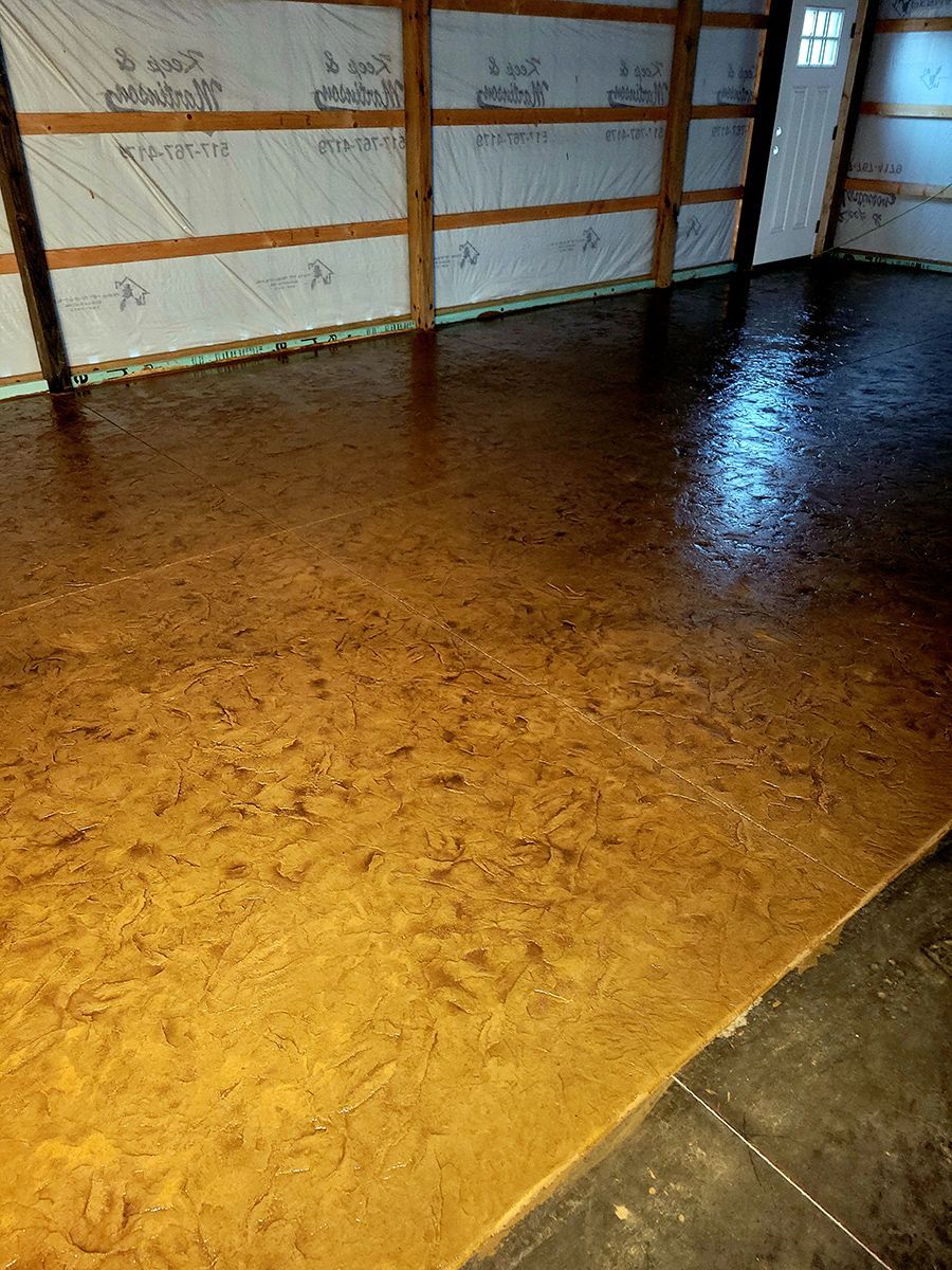 A garage with a concrete floor and wooden walls.