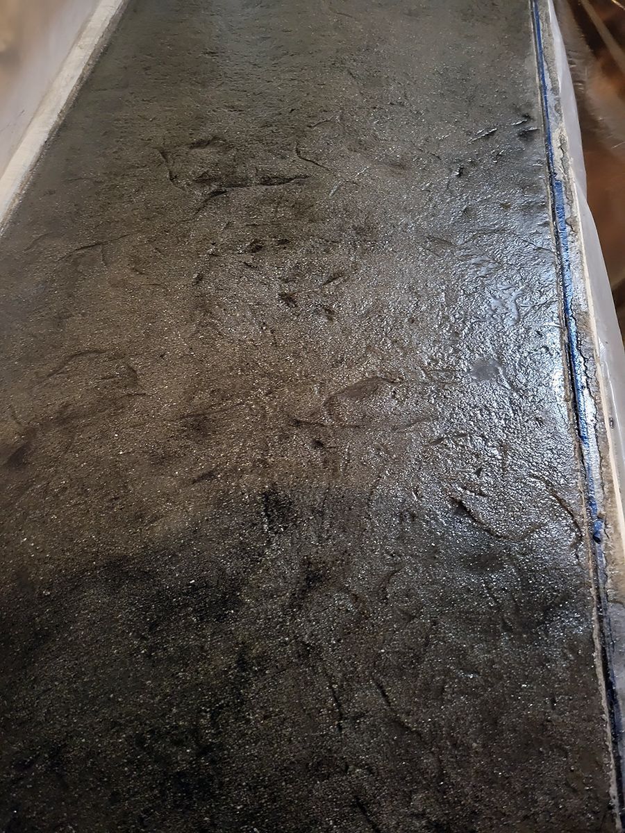 A close up of a black surface with a lot of dust on it.