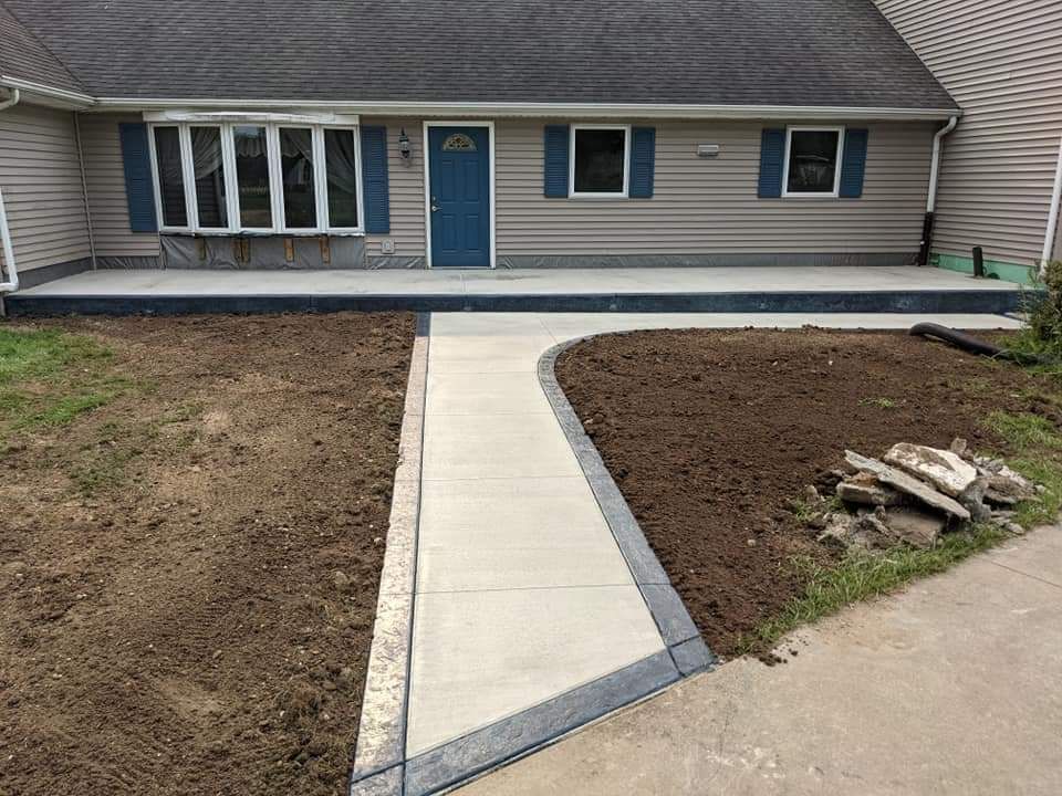 A house with a concrete walkway leading to the front door.