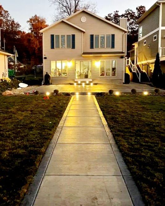 A house with a concrete walkway leading to it