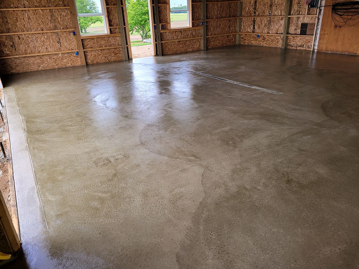 A concrete floor in a garage under construction.