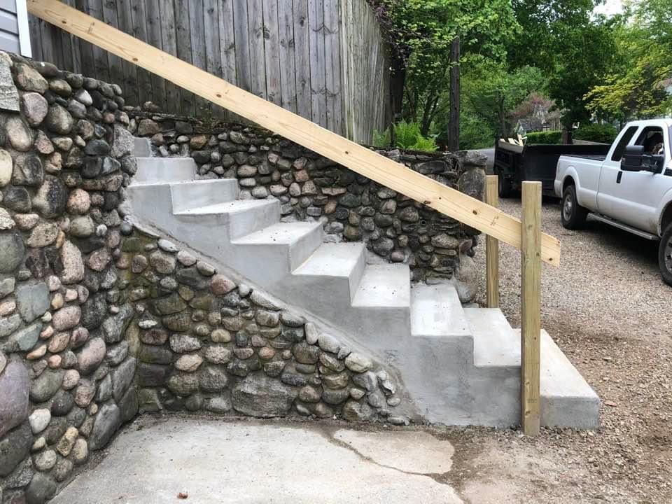 A white truck is parked next to a set of stairs