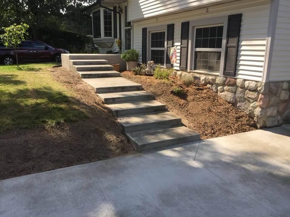 A set of concrete steps leading up to a house.