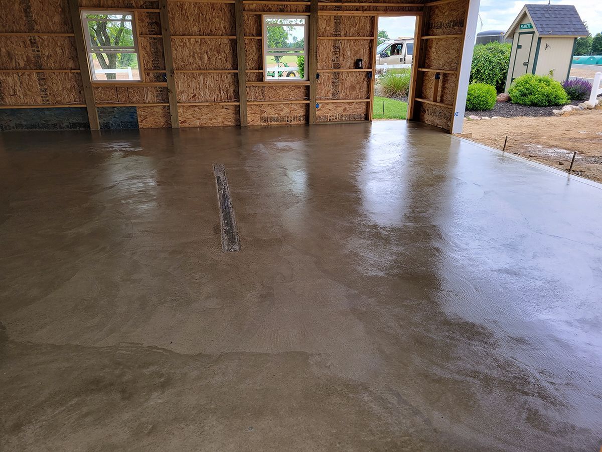 A concrete floor in a garage under construction.