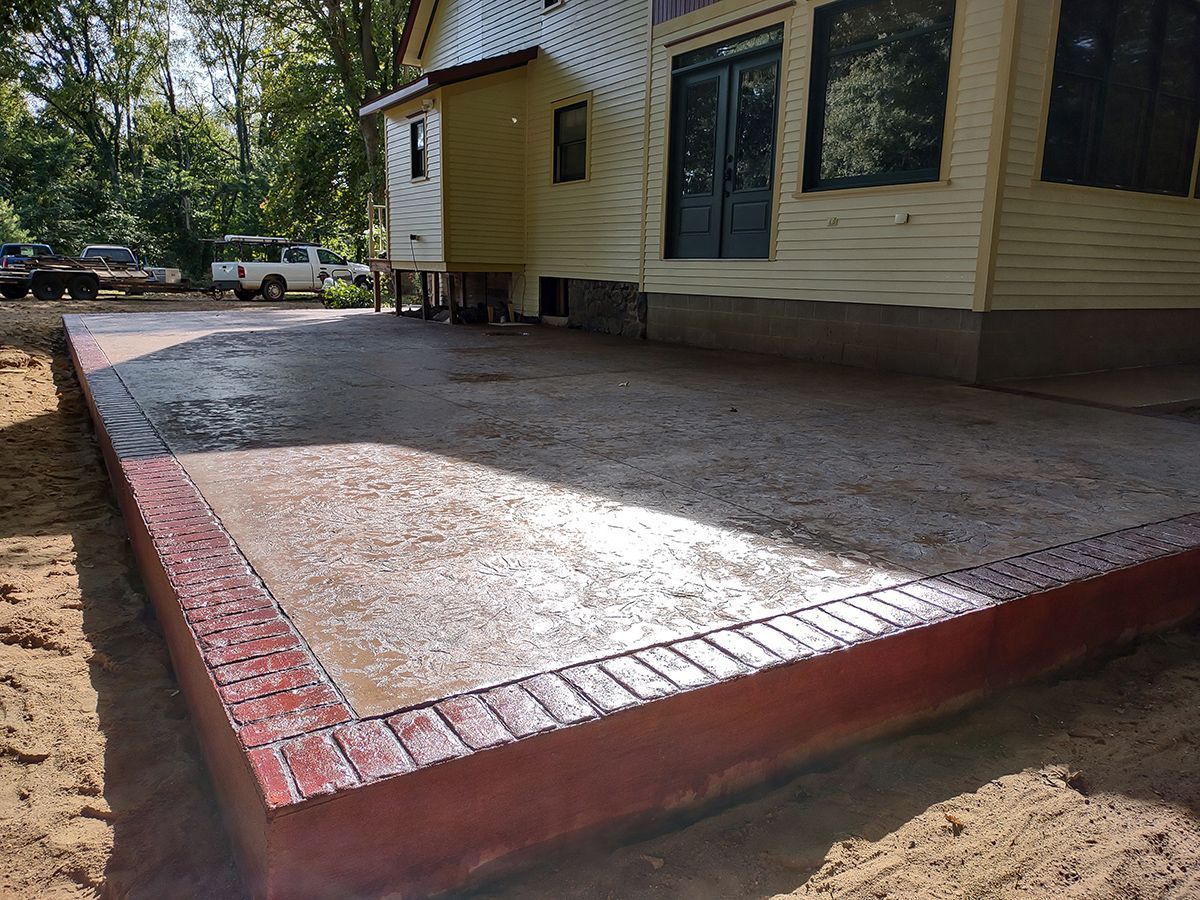 A large concrete patio in front of a house.