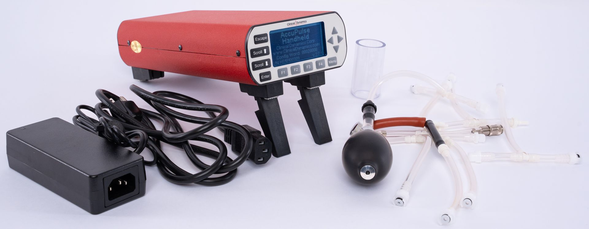 Red handheld device with cables, charger, and probe accessories laid out on a white background