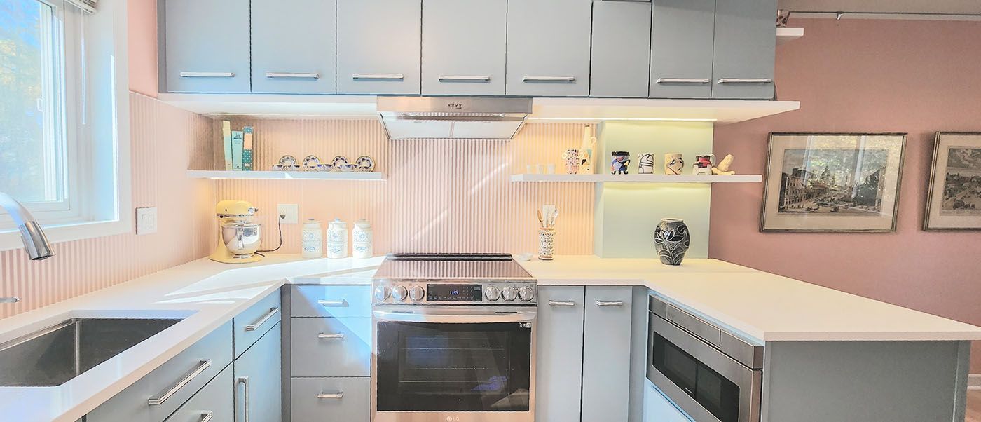 A kitchen with a stove, sink, and microwave