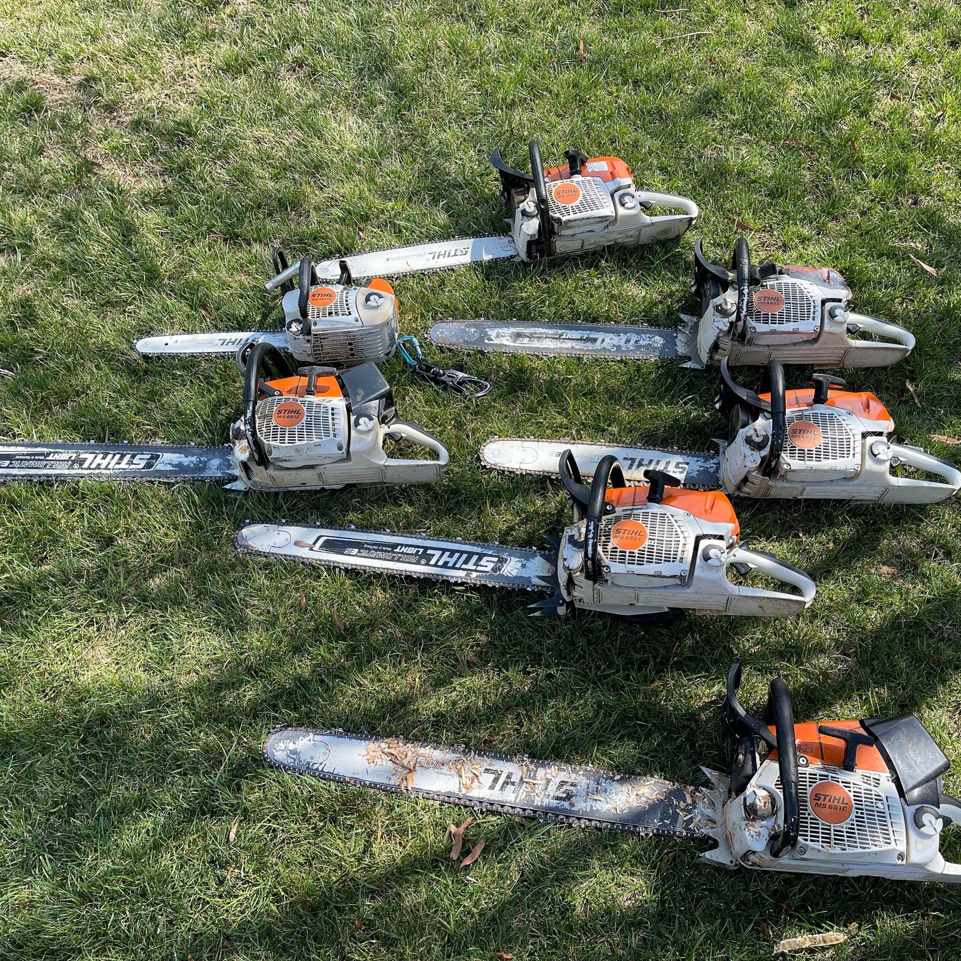 Multiple chainsaws on the ground