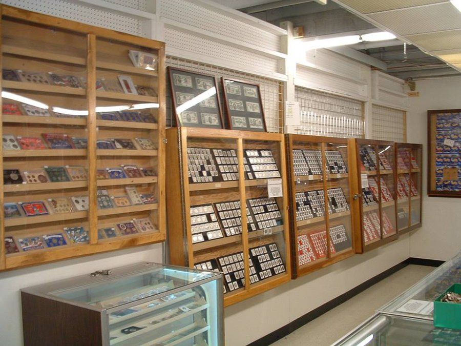 Silver dollars and gold coins in collectors album