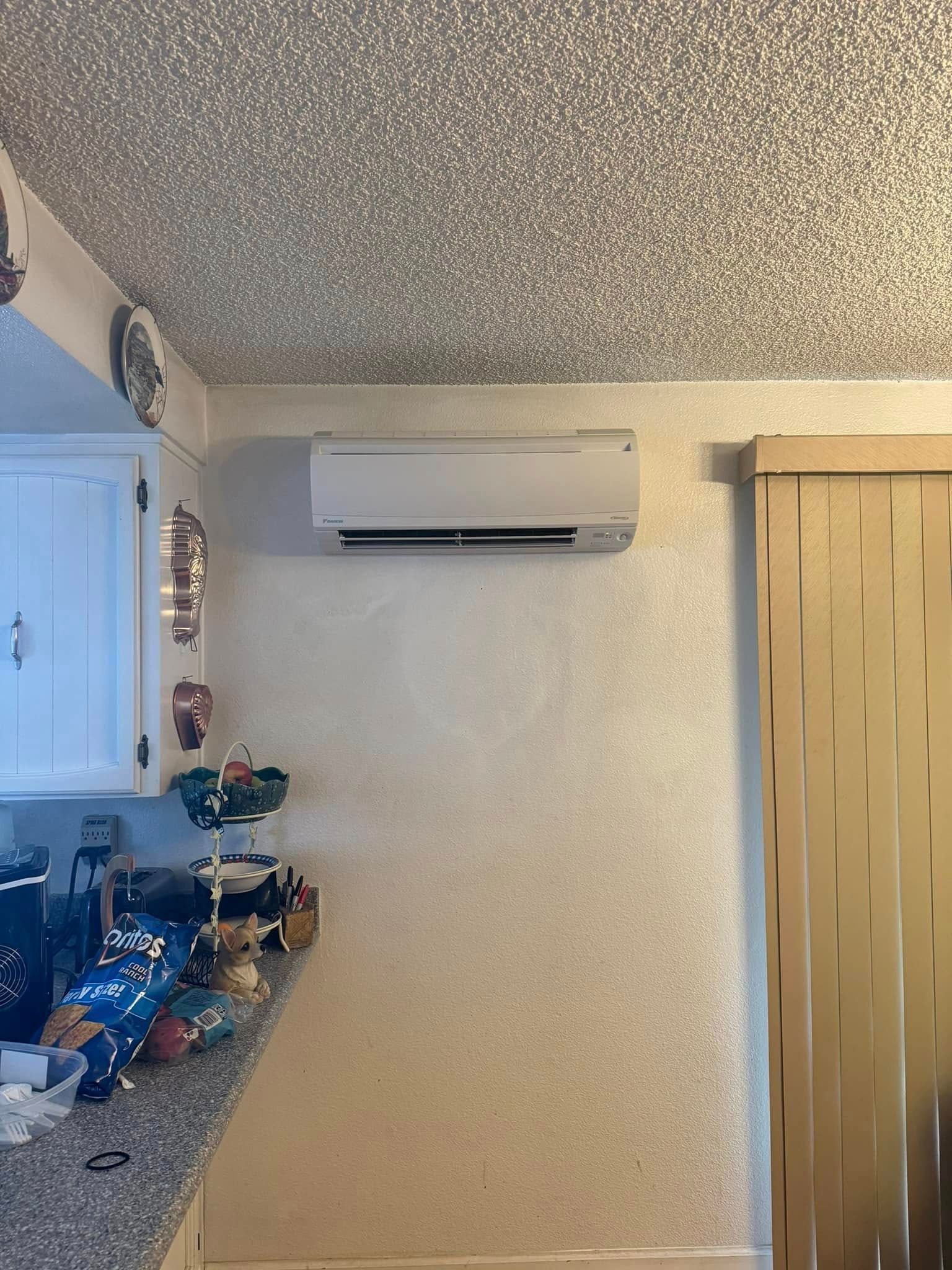 A kitchen with a ceiling fan mounted to the wall.