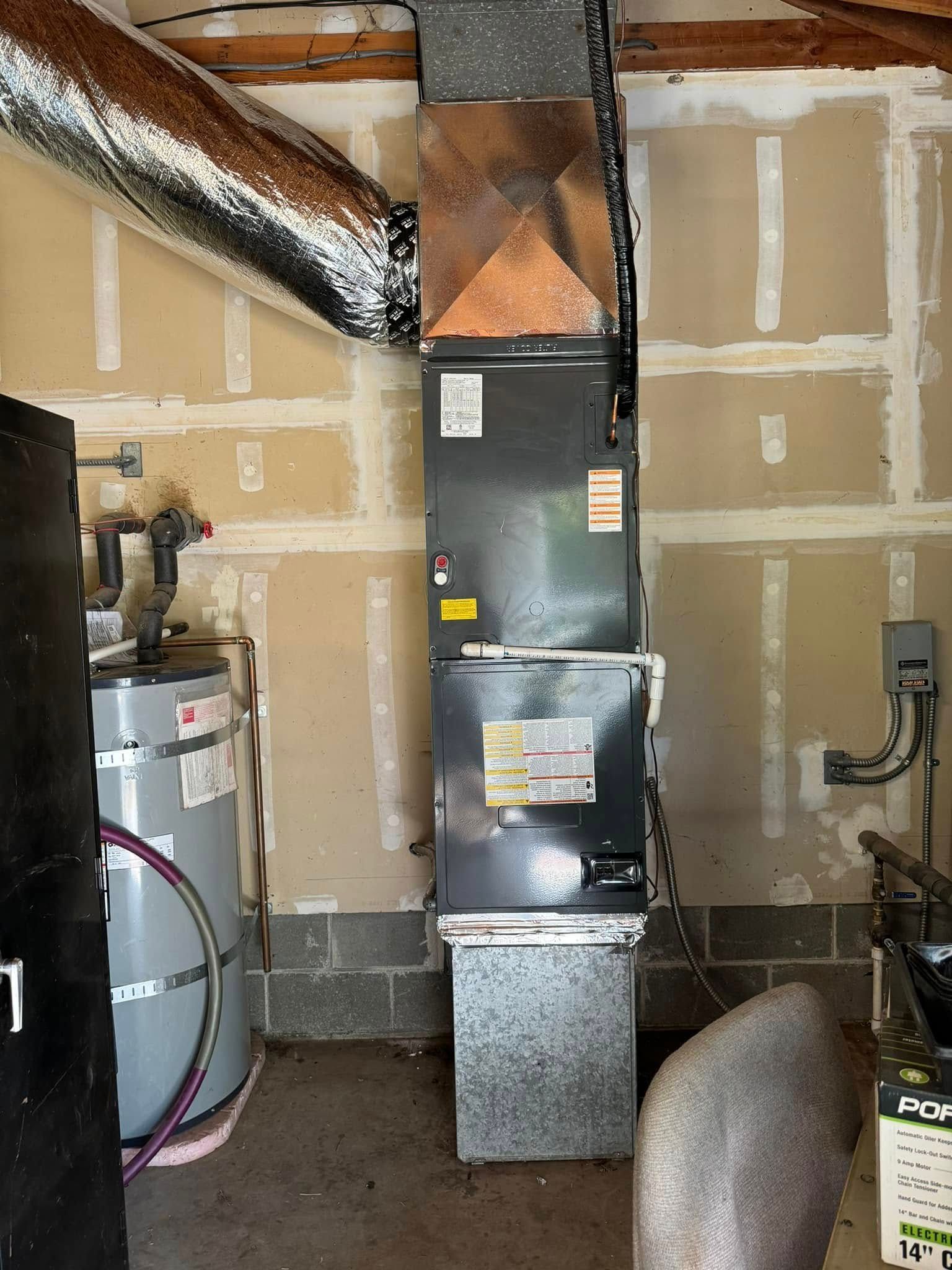 A room with a water heater and a furnace in it.